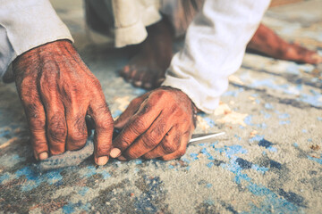 Closeup of hands cutting carpet with scissors. Carpet cleaning service