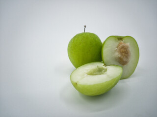 Indian jujube fruit or Ziziphus mauritiana or buah bidara in a rattan bowl. Blurred background