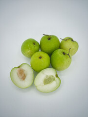 Indian jujube fruit or Ziziphus mauritiana or buah bidara in a rattan bowl. Blurred background