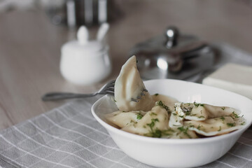 Dumplings, filled with potatoes and served with butter and fennel. Varenyky, vareniki, pierogi, pyrohy. Dumplings with filling.