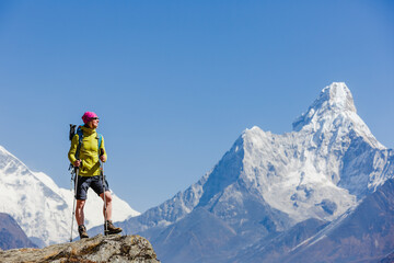 Hiking in Himalaya mountains. Woman Traveler with Backpack hiking in the Mountains. mountaineering sport lifestyle concept