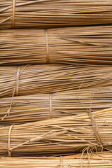 Blocks of dry cattail plant in a row