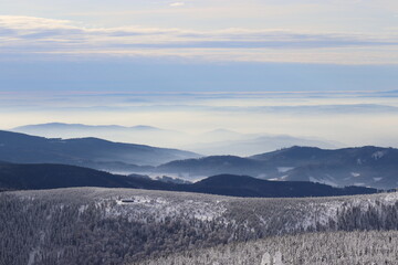 A view from the peak of the mountain Praded to the landscape in haze in Jeseniky, Czech republic