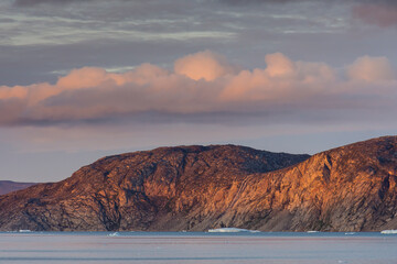 Greenland. Disko Bay. Sunset on the arid coastline of Greenland.