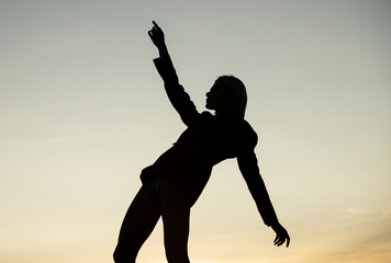 Fototapeta na wymiar dark figure silhouette of dancing woman outdoor, inspiration