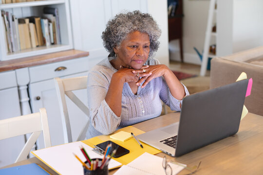 Thoughtful african american senior woman having a video call on laptop at home
