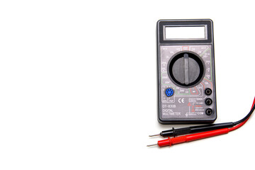 Electronic digital multimeter isolated on white with probes. Digital meter with red and black wires. Electronic tester isolated on white background close up