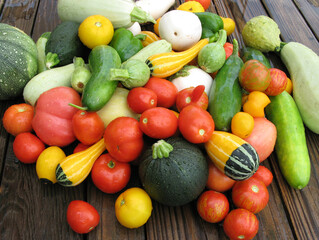 Freshly picked summer harvest of vegetables including tomatoes, cucumbers,squash and eggplant.