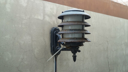 Old and rusty lamps on the wall of villa