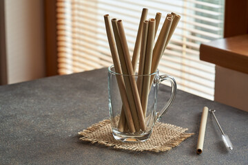 Bamboo straws in a transparent glass - zero-waste or ecology concept