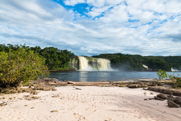 Naklejka premium View of Waterfall Ax (Salto Hacha) falling on the lagoon in Canaima National Park (Venezuela).