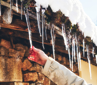woman catching a stalactic in a frozen house