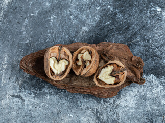 Some of opened healthy walnuts on a gray background