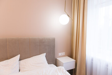 Design of a modern bedroom with hanging tables and lamps