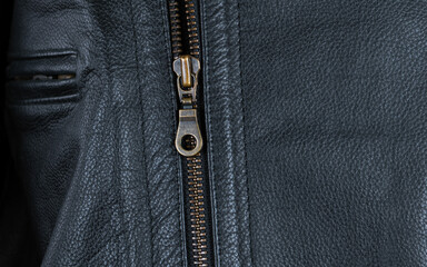 Close up of metal zipper on black leather jacket