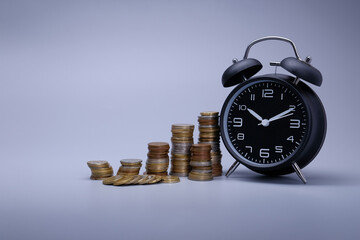 Close up of time and money with grey background ,Business Finance and Money concept,Save money for prepare in the future.time is money concept