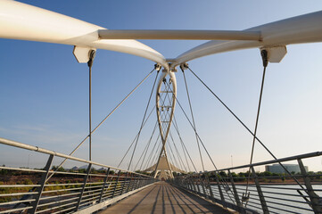 Pedestrian bridge over Tempe Town Lake in Arizona, highlighting its architectural design against the sky