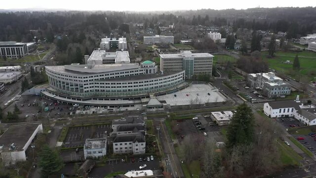 Cinematic aerial drone footage of downtown Olympia, Washington State department buildings, Department of Natural Resources, East Campus plaza, capitol building campus area in Olympia, Washington