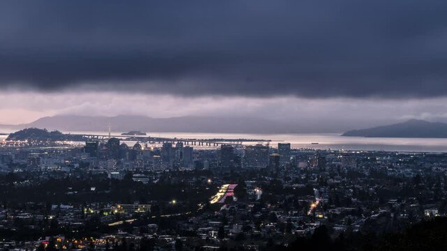 Time Lapse of Traffic and Oakland Skyline At Night with Passing Clouds