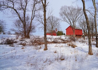 View of a traditional red barn in winter after a snowfall in New Jersey, United States