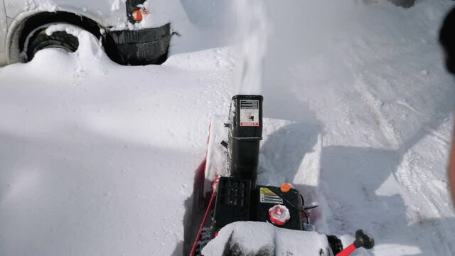 POV remove snow from parking lot using snow blower machine. Slow motion. High angle view