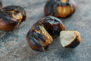 Delicious fried chestnuts on a gray background
