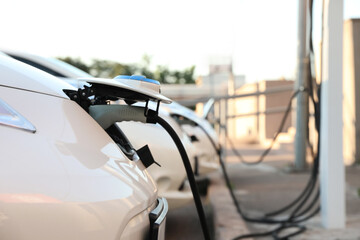 Charging modern electric cars from station outdoors