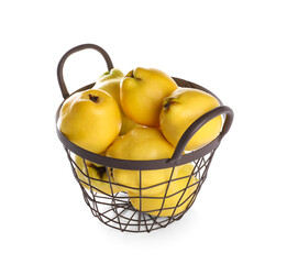 Fresh ripe quinces in basket on white background