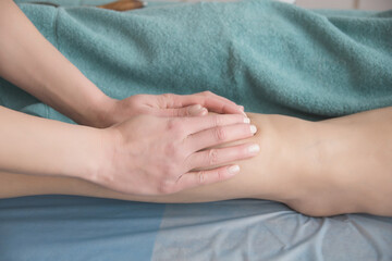Fototapeta na wymiar anti-cellulite foot massage in the spa salon makes the girl