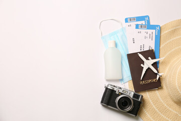 Composition with passport and protective mask on white background, top view. Travel during quarantine