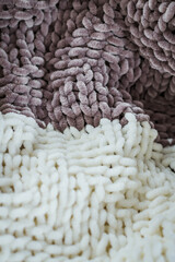 Close-up texture of knitted brown velour blanket. Knitted pattern.