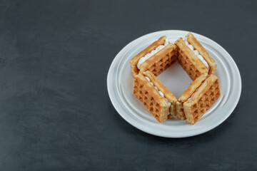 Delicious fresh waffles on a dark background