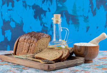 Slices of fresh loaf of bread on a wooden board