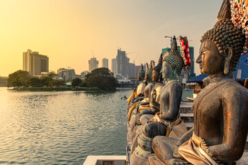 Statue of Buddha, traditional vs modern Colombo city of Sri Lanka