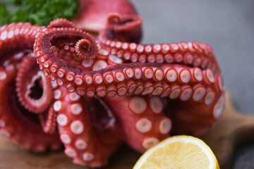 Octopus food cooked salad seafood squid cuttlefish, Boiled octopus tentacles with lemon on cutting board © Bigc Studio