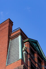Brick building corner with blue sky background