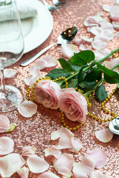 Romantic table set up for valentine, set with pink rose petal