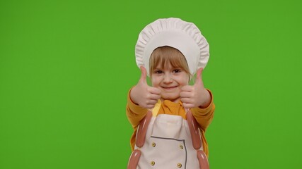 Child girl kid with sausages dressed as cook chef showing thumbs up, smiling, invites you to join, come. Nutrition, cooking school, education, food. Fun and humor. Chroma key background. Copy-space