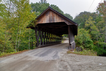 Rustic covered wooden bridge on a gray day