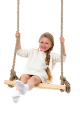 Cute long haired girl sitting on rope swing