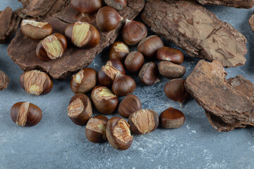 Delicious healthy chestnuts on a tree bark