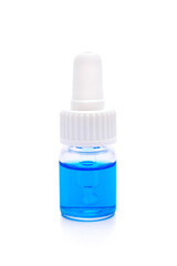 glass bottle with pipette with blue liquid on white background