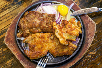 A tempting three kinds of meat steak platter, pork steak chicken steak steak
