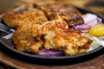 A tempting three kinds of meat steak platter, pork steak chicken steak steak