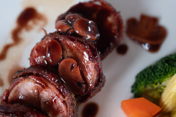 Close up view of tasty bacon wrapped steaks on with dish