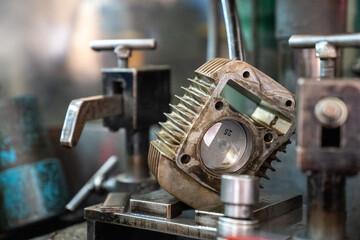 Cylinder motorcycle stands on the grinding machine.