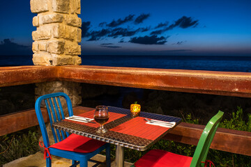 A table at a cute little oceanside cafe is set for two