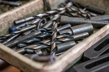 Drill bits for working in a garage. Photo with noise.