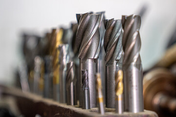 Drill bits for working in a garage. Photo with noise. - obrazy, fototapety, plakaty