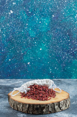 Sack of dried cranberries on wooden piece